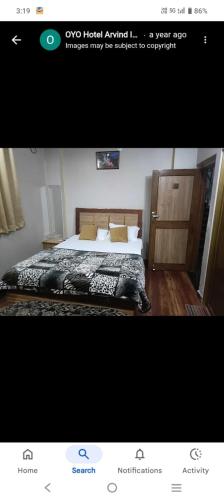 a picture of a bedroom with a bed in a room at Hotal Arvind in Patna