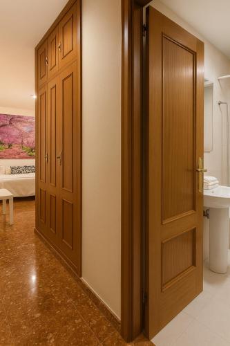 a hallway with two wooden doors in a room at Hotel Al-Ándalus Peal, en Cazorla Comarca in Peal de Becerro
