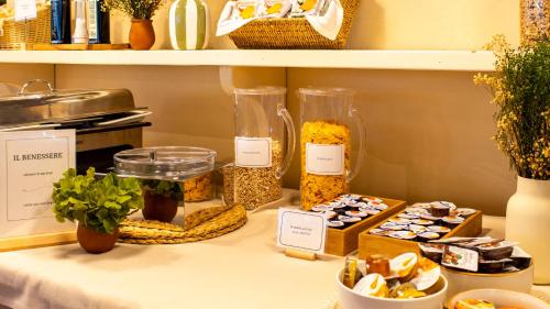 a table with jars of food on a shelf at Country Hotel Residence Da Pilade in Capoliveri