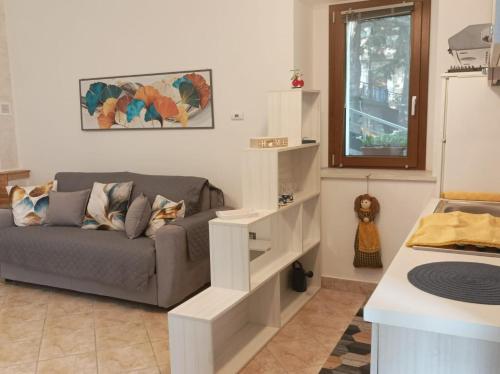 a living room with a couch and a window at Casa Vacanze Nausicaa in Tiriolo