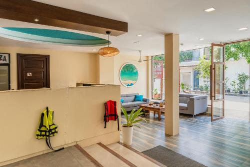 a living room with a couch and a table at Kue Hotel Maafushi in Maafushi