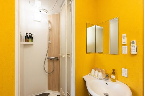 a bathroom with a sink and a shower at Select Inn Numazu in Numazu