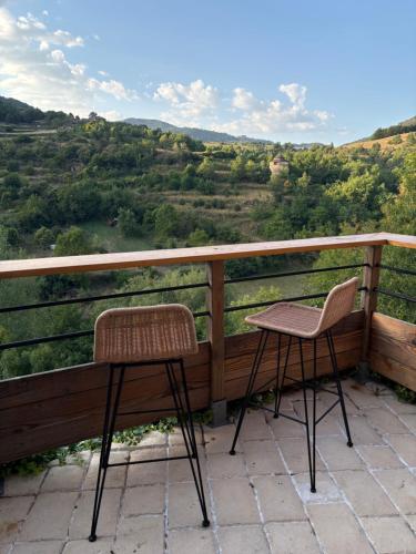 two chairs on a balcony with a view at Casa Rocatalhada, petit cocon surplombant la Muse in Marzials