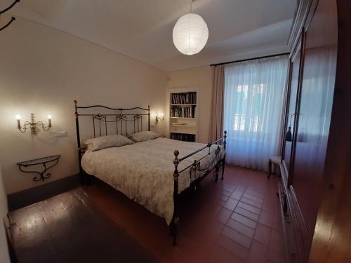 a bedroom with a bed and a large window at Tuscan Hilltop Getaway in Montecastelli Pisano
