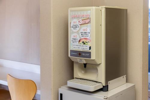 a computer sitting on a table next to a chair at Select Inn Numazu in Numazu