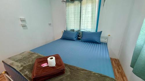 a blue bed with a roll of toilet paper on it at Phangan long island Bar in Koh Phangan
