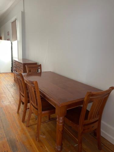 a dining room with a wooden table and chairs at Apartment 2 on OxideCBD in Broken Hill