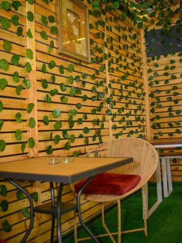 a table and chairs in front of a wooden wall at Pentagon by Riz Royalty Homes in Magodo