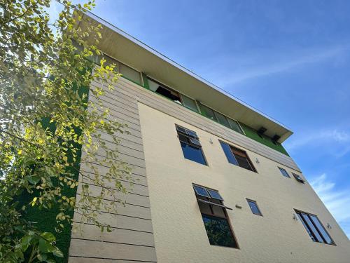a building with windows on the side of it at Kue Hotel Maafushi in Maafushi