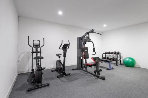 a gym with several treadmills and exercise bikes at Hotel Tropicana Pattaya in Pattaya