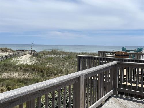 a deck with a view of the beach and the ocean at 38 Piece Of Heaven Condo in Hatteras