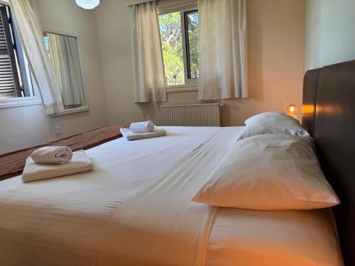 a large white bed with two pillows on it at Jubilee Hotel Troodos in Troodos