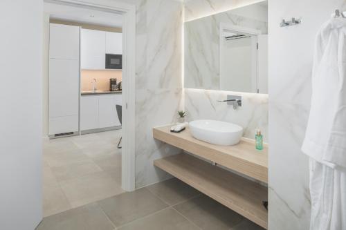 a white bathroom with a sink and a mirror at Maj Luxury Residence in Poreč