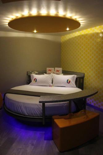 a bedroom with a bed with a light above it at Oh! Oriente Hotel in Mexico City