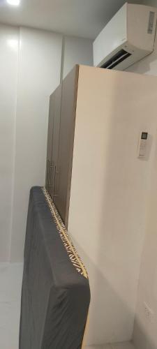 a black couch in a room with a wall at LV Residences Siargao in Dapa