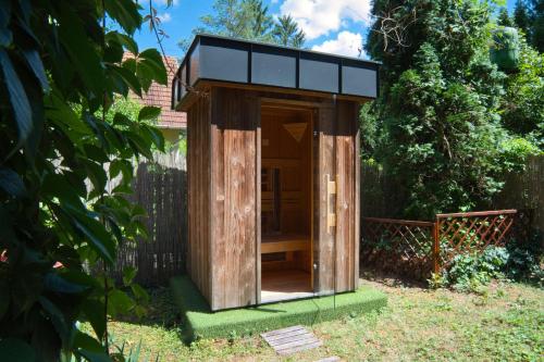 a wooden out house in a garden at Paulanyi's Island Heart of Woods, Szentendre Island in Szigetmonostor