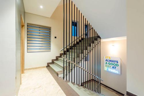 a staircase in a house with a black railing at Treebo Deluxe Inn, Chromepet in Chennai