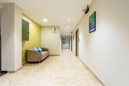 a corridor of a hospital with a couch in a hallway at Treebo Deluxe Inn, Chromepet in Chennai