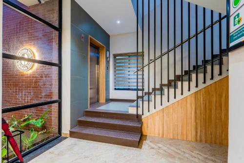 a staircase in a house with a brick wall at Treebo Deluxe Inn, Chromepet in Chennai