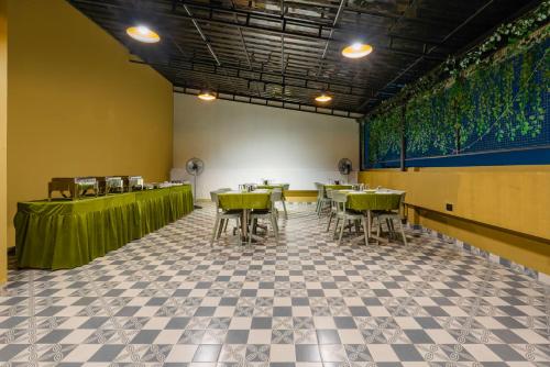 a restaurant with tables and chairs in a room at Treebo Deluxe Inn, Chromepet in Chennai