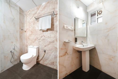 a bathroom with a toilet and a sink at FabHotel Skyline in Bengaluru