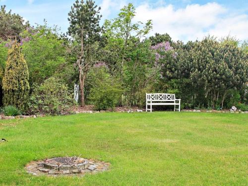 a park bench sitting in a field of grass at 4 star holiday home in Dannemare in Dannemare