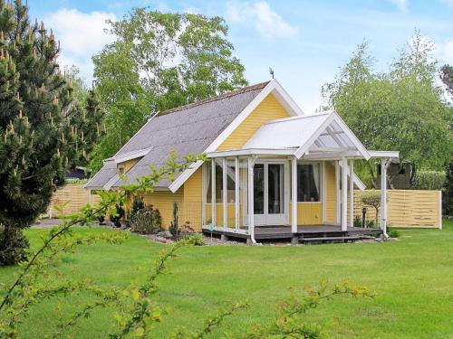 a small yellow house with a white roof at 4 star holiday home in Dannemare in Dannemare