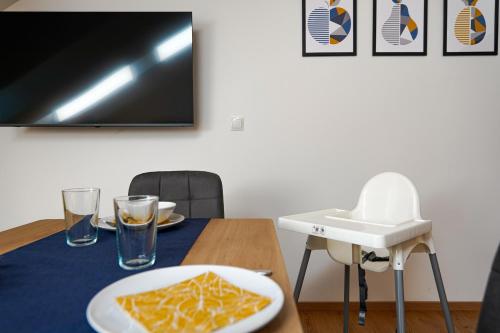 a table with a plate of food on a table at CitySuites Salzburg in Salzburg