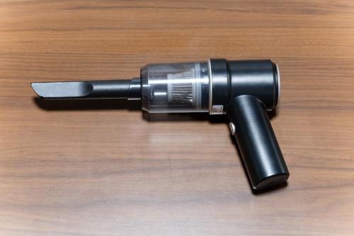 a black flashlight sitting on top of a wooden table at SENJU Nakacho HOUSE , 千住仲町HOUSE in Tokyo