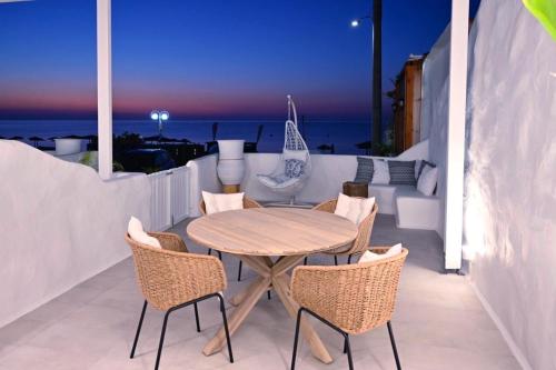 a table and chairs on a balcony with the ocean at Rodhéa in Rhodes Town
