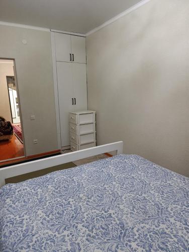 an empty bedroom with a bed and a mirror at Дача in Vorontsovskoye