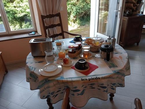 a table with breakfast food on top of it at LES ROCHES DE COIGNE in Sainte-Anne-sur-Vilaine