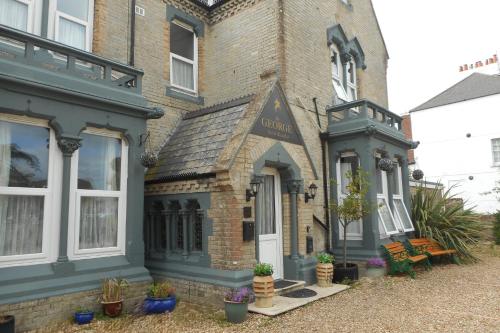 a building with a sign on the front of it at The George B & B in Weymouth