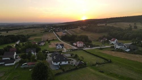 an aerial view of a village with houses and the sunset at Agroturystyka Szklana Polana in Huta Szklana