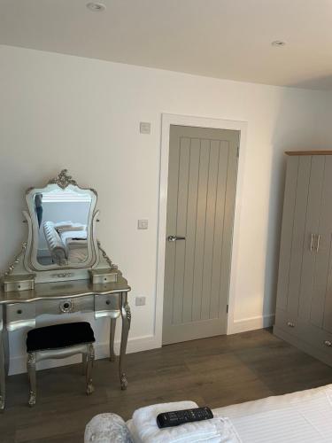 a bedroom with a vanity with a mirror on it at Bay view apartment in Penzance
