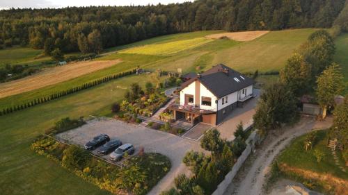 an aerial view of a house with cars parked in the driveway at Agroturystyka Szklana Polana in Huta Szklana