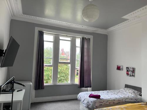 a bedroom with a bed and a window at Triple room Private Bath Near LFC Free Street Parking No Breakfast in Liverpool