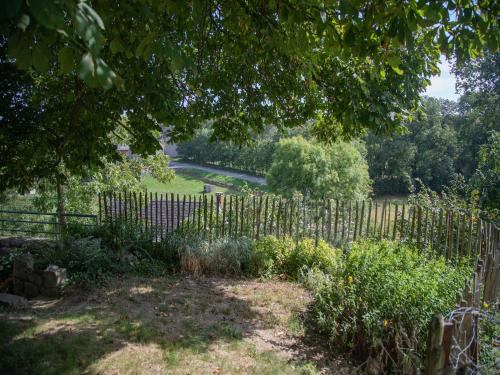 a wooden fence in a yard with a garden at Tranquil Stay in Ardennes in Doische