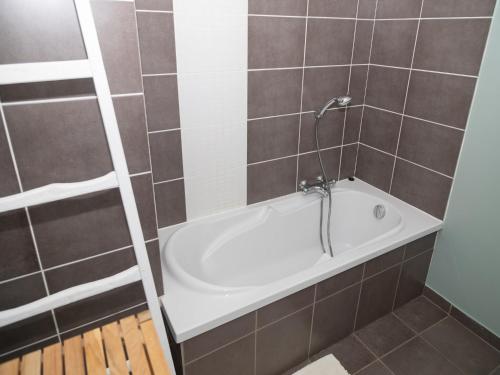 a bathroom with a bath tub with a shower at Tranquil Stay in Ardennes in Doische
