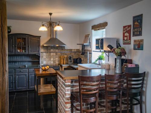 a kitchen with a table and some chairs in it at Tranquil Stay in Ardennes in Doische