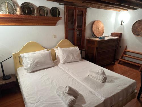 a bedroom with a bed with towels on it at Molos ONE in Skiros