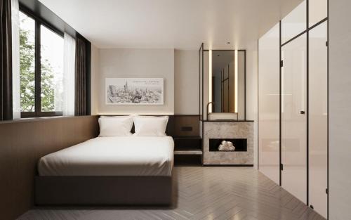 Postel nebo postele na pokoji v ubytování PureJoy Hotel Saigon