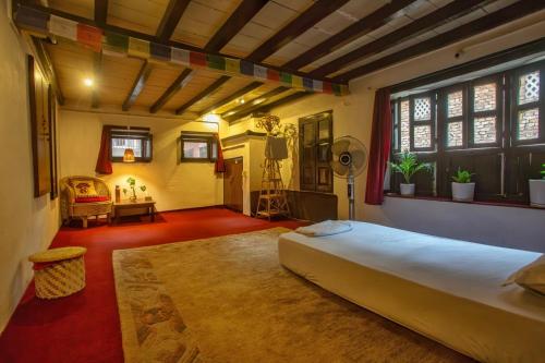 a bedroom with a large bed in a room at Traditional Newari Homestay in Pātan