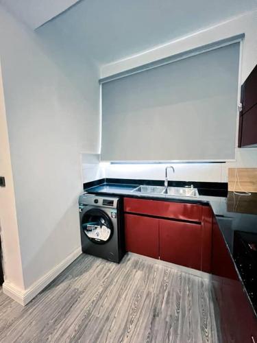 a kitchen with a washing machine and a sink at TheHubCentral in Lekki