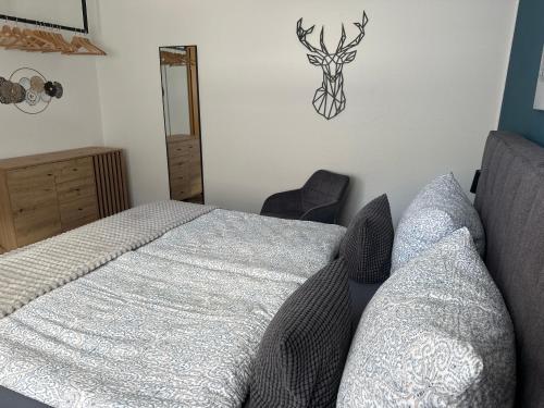 a bedroom with a bed and a deer head on the wall at Ferienwohnung "Apartment Sunlife Winterberg" 4 Sterne in Winterberg