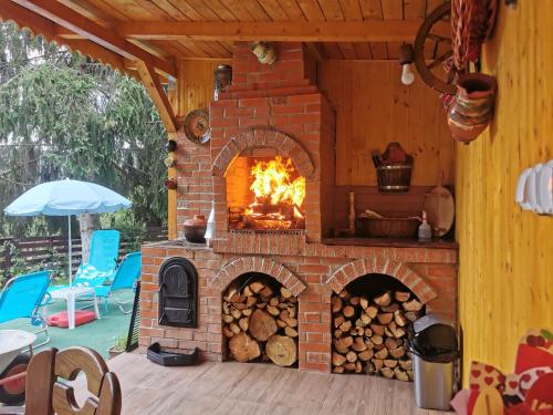a brick oven with a fire in it at Casa de vacanta 1001 De Nopti in Corbşori