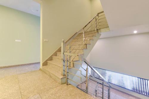 a staircase in a building with a metal railing at FabHotel Shivansh in Jaipur