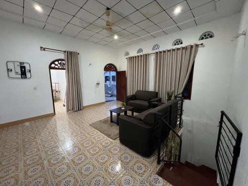 a living room with a couch and a table at StayEase in Batticaloa
