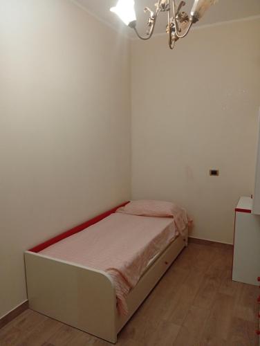 a small white room with a bed in it at Varacalli home in Siderno Marina
