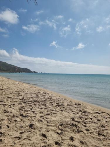 a sandy beach with a view of the ocean at Balcony of Carthage in Bin Rhilouf